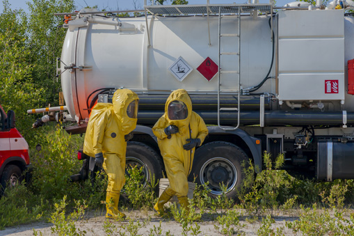 firefighting-course-mans-with-briefcase-in-protective-hazmat-suit