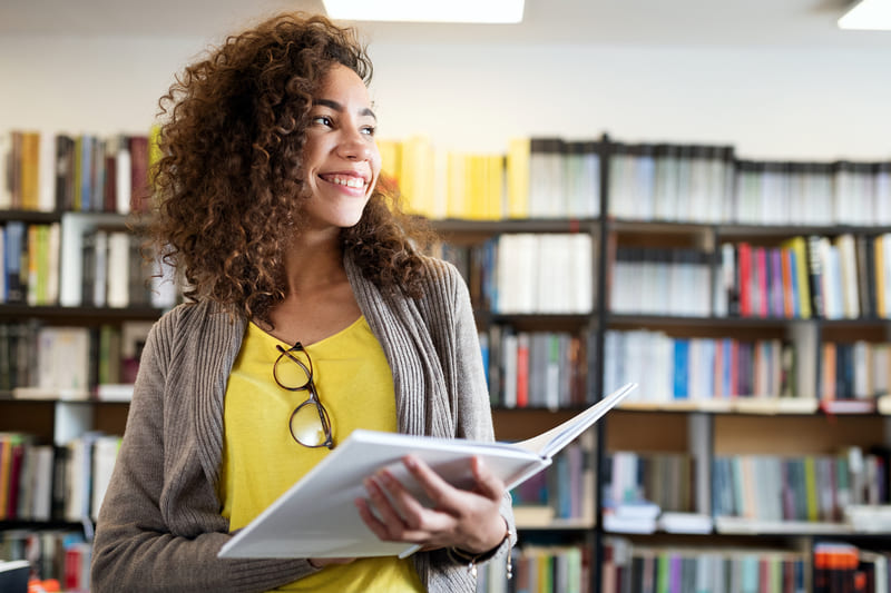 first-aid-course-education-high-school-university-learning-and-people-concept-smiling-student-girl-reading-book