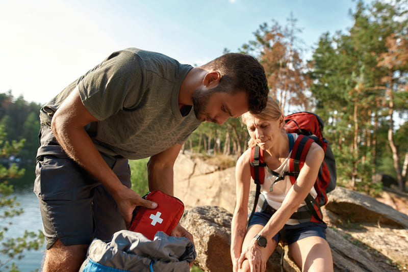 first-aid-course-young-man-using-first-aid-kit-on-injured-leg