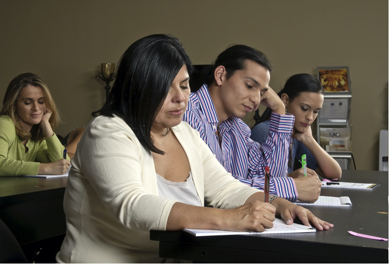 health-and-safety-training-employees-desk-taking-notes