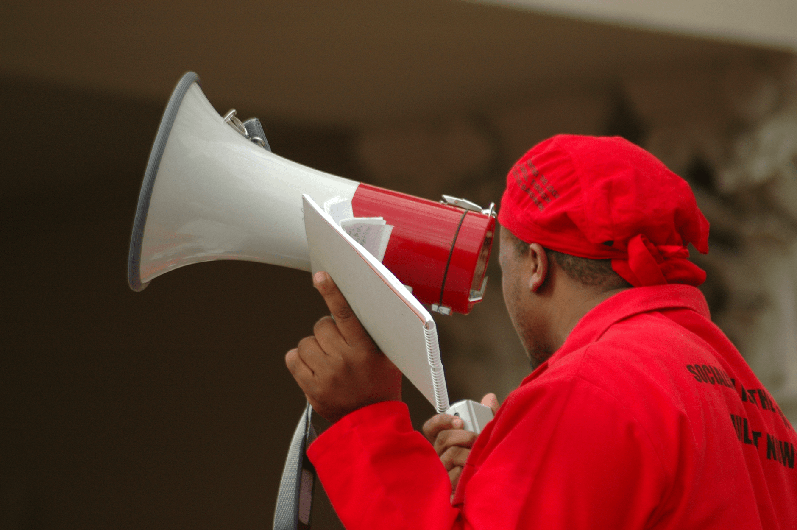 health-and-safety-training-man-megaphone-red-outfit-min