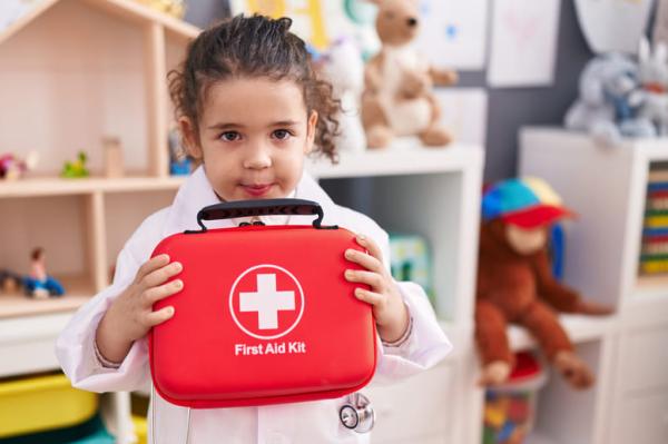 33-0.first-aid-training-hispanic-girl-wearing-doctor-uniform-holding-first-kit-aid-at-kindergarten.0f3bdebdefe9ebf474b5c39afce0e772