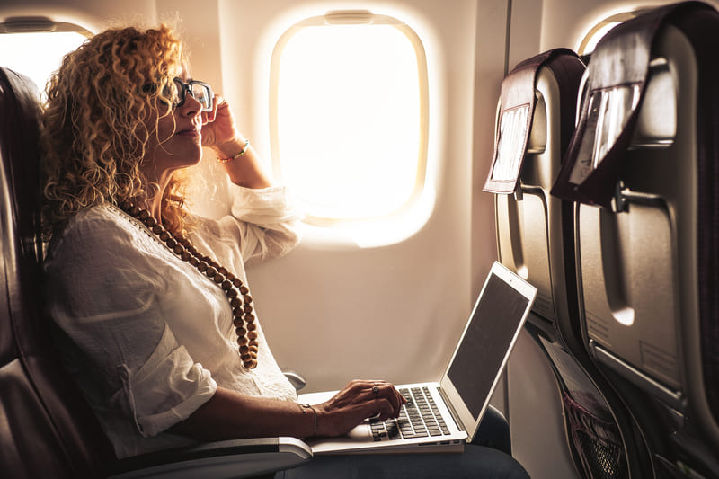 first-aid-course-business-adult-beautiful-curly-blonde-woman-travel-on-airplane-connected-to-internet-with-modern-computer-laptop-people-on-work
