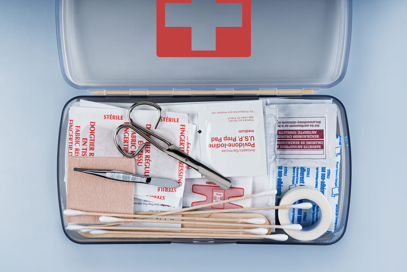 first-aid-course-first-aid-kit-packed-with-medical-supplies-on-grey-background