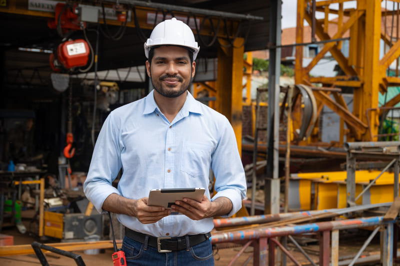 safety-officer-course-portrait-hispanic-indian-construction-engineer-male-worker-at-construction-site-with-safety-hard-hat
