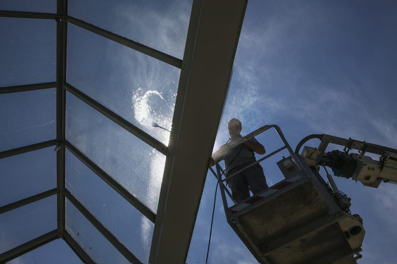 working-at-heights-worker-of-professional-facade-cleaning-services-washing-a-glass